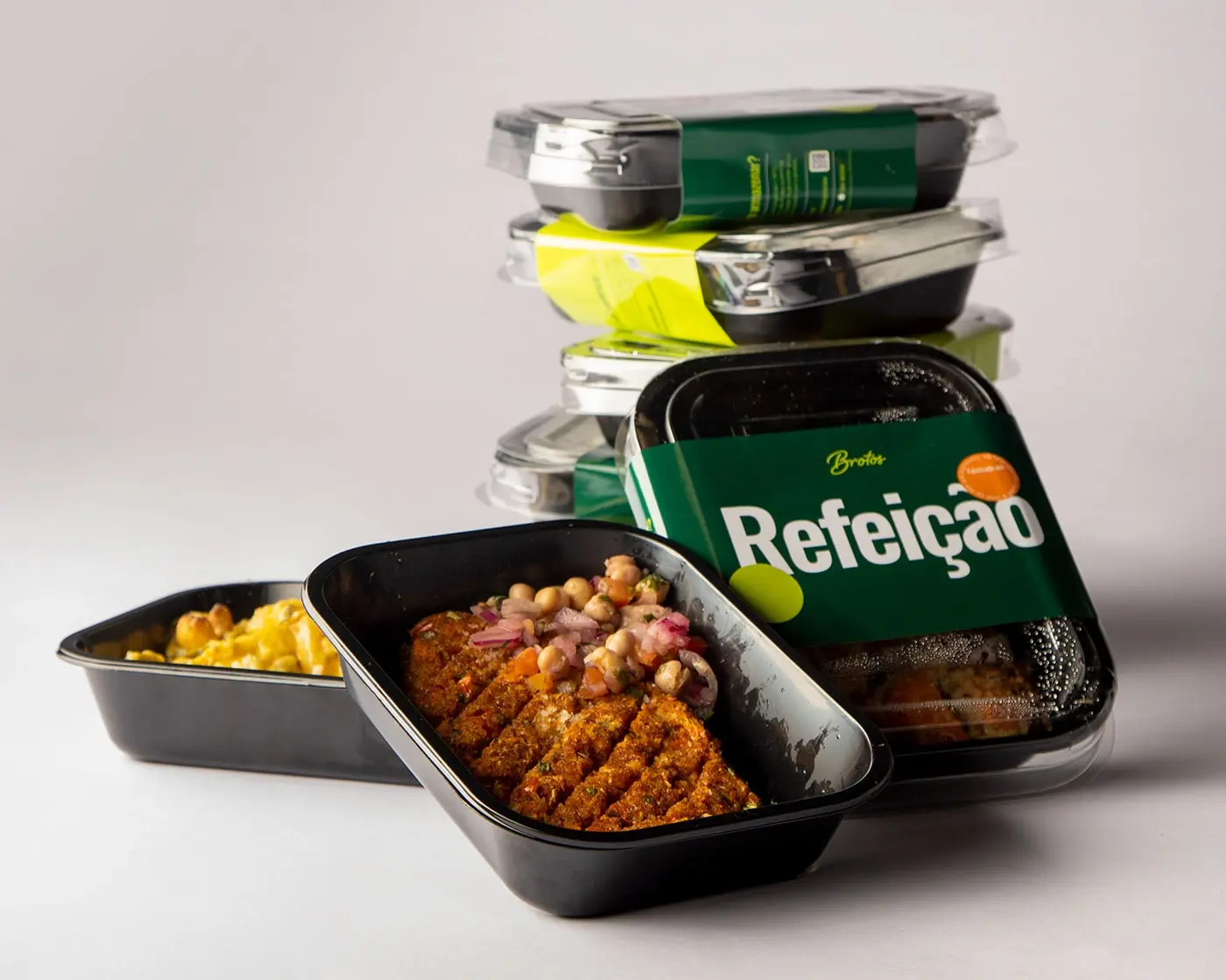 Primary Packaging Shot: "A vibrant packaging of Brotos Salad showcasing a rich green background adorned with lively pop colors illustrating the fresh and healthy ingredients contained within.