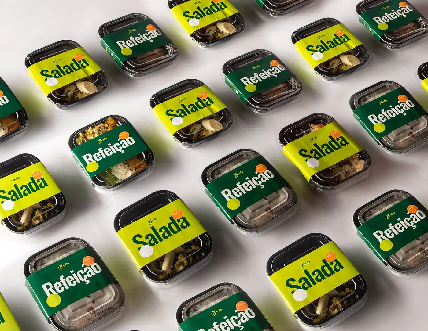 Range Display: "A delightful display of Brotos Salad product range, with each packaging showcasing a vibrant blend of green and pop colors, promising a burst of freshness and health with every product.